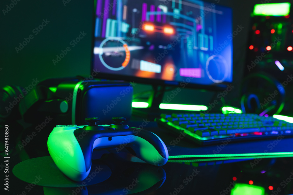 Aufkleber composite of computer, keyboard with video game accessories with copy space on neon background