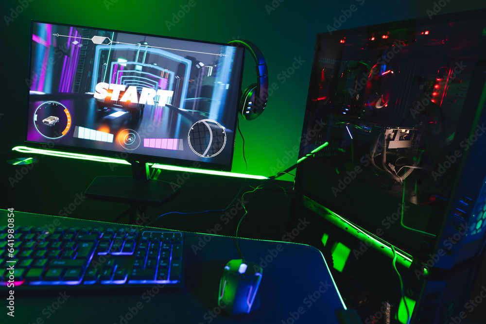 Poster composite of computer, keyboard with video game accessories with copy space on neon background