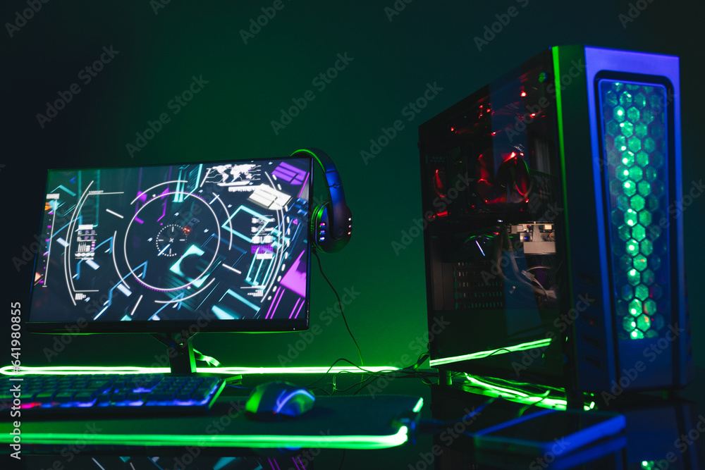 Poster composite of computer, keyboard with video game accessories with copy space on neon background