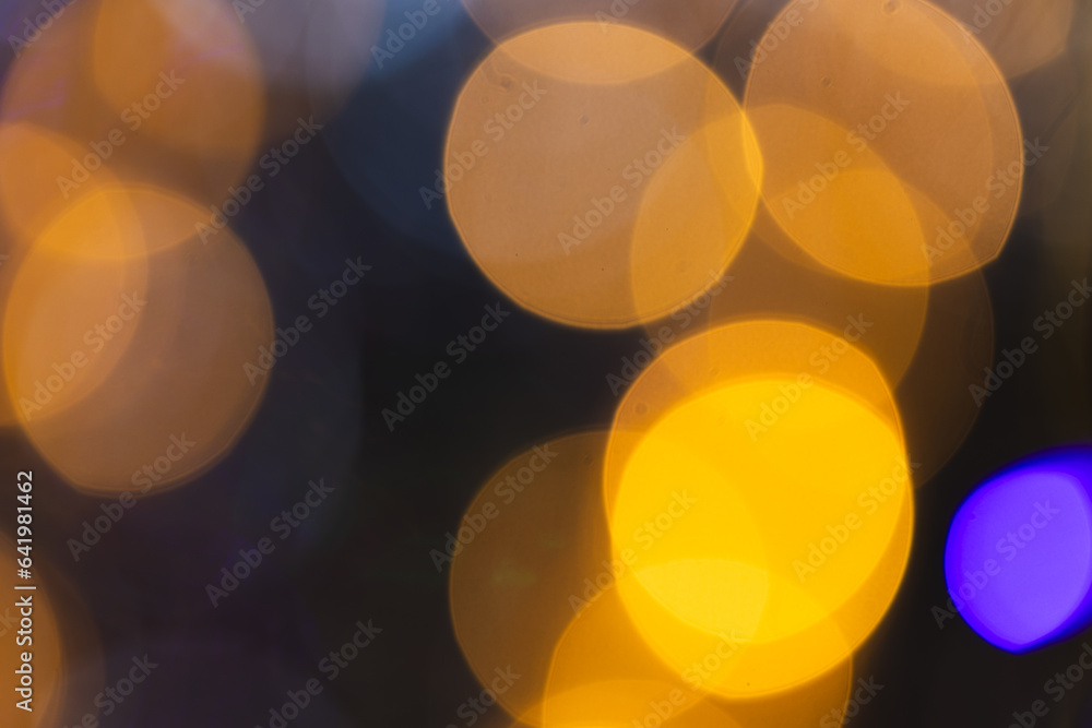 Poster multiple yellow and blue bokeh lights with copy space on dark background
