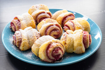 puff pastry swirls with jam on a black background. diet. food concept. healthy food
