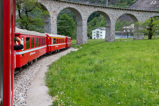 The Bernina Express under The famous Brusio spiral viaduct. Brusio, Switzerland, 6 May 2023.
