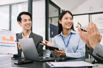 Fototapeta premium Asian business people working as a good team in the office. Successful teamwork in a meeting, workplace concept.
