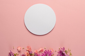 Pink flowers and white circle with copy space on pink background