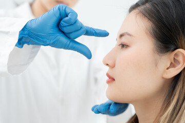 plastic surgery, beauty, Surgeon or beautician touching woman face, surgical procedure that involve...