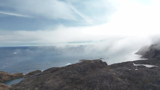 aerial view of glaciers on arctic ocean in foggy sky