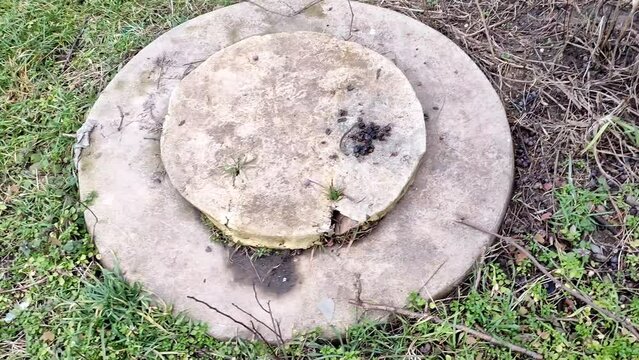 Septic tank hatch on a ground in the private garden
