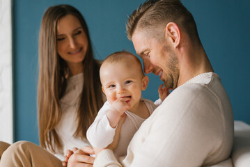 Happy Caucasian family with a small child laughs and smiles.