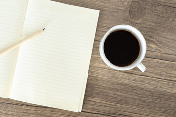 Obraz na płótnie Canvas cup of coffee and notepad
