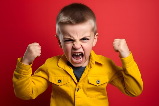 Studio portrait of a little boy being determined, having fists clenched, isolated on colorful background. Kids emotions or moods concept. Generative AI