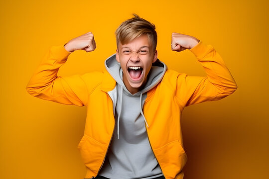 Studio portrait of a teenager boy being proud and victorious, isolated on colorful background. Teenager emotions or moods concept. Generative AI