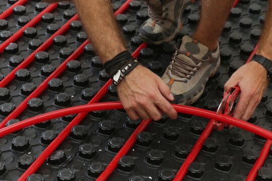 Water underfloor heating systems installation, work in progress on construction site for a flat residence building