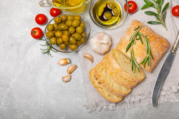 Ciabatta and olives. Fresh italian ciabatta bread with herbs, olive oil,parmesan and pesto sauce,...