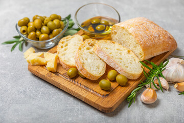 Ciabatta and olives. Fresh italian ciabatta bread with herbs, olive oil,parmesan and pesto sauce,...