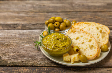 Ciabatta and olives. Fresh italian ciabatta bread with herbs, olive oil,parmesan and pesto sauce,...