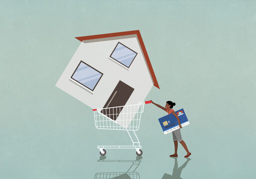 Woman with credit card pushing house in shopping cart
