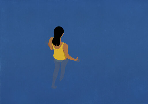 Woman walking into blue water
