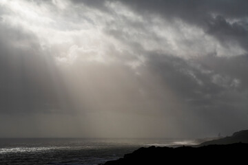 Grey sky with sun rays and thunder, United Kingdom, England
