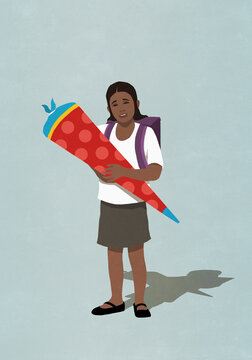 Portrait schoolgirl holding large dunce cap
