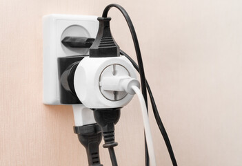 multiple plugs plugged into one outlet. electricity overload