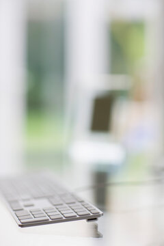 Close up of keyboard on a glass table
