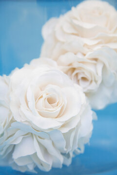 Extreme close up of two fabric white roses
