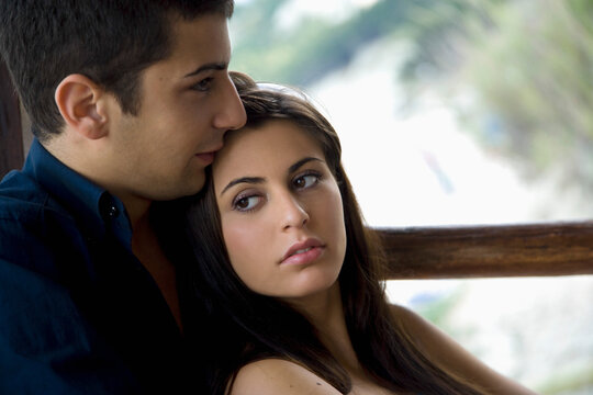 Portrait of young couple snuggling
