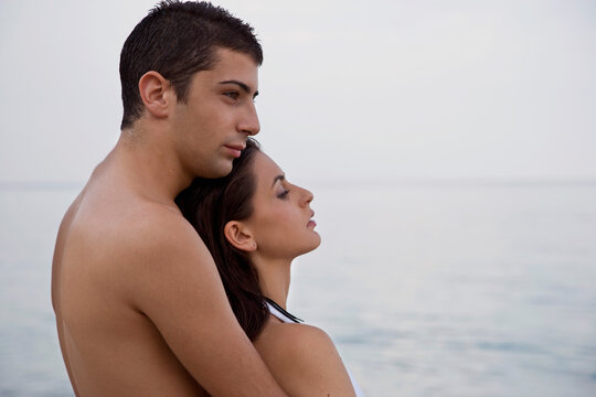 Young couple embracing on beach
