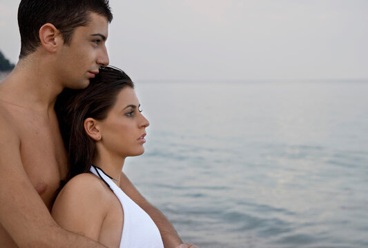 Young couple embracing on beach
