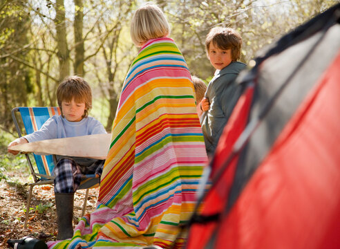 Children at campsite looking at map
