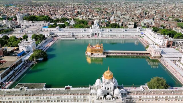 Amritsar, India: Aerial view of famous city in Punjab, iconic landmark The Golden Temple (Harimandir Sahib) - landscape panorama of South Asia from above