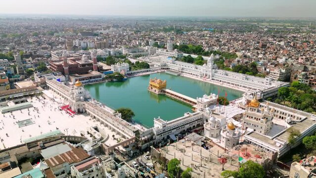 Amritsar, India: Aerial view of famous city in Punjab, iconic landmark The Golden Temple (Harimandir Sahib) - landscape panorama of South Asia from above