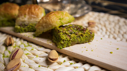 Layers of pistachio baklava in a decorated setting