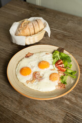 Bacon and eggs with vegetables and bread