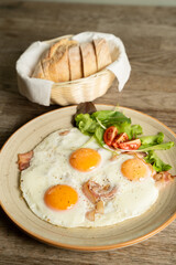 Bacon and eggs with vegetables and bread