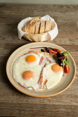 Ham and eggs with vegetables and bread