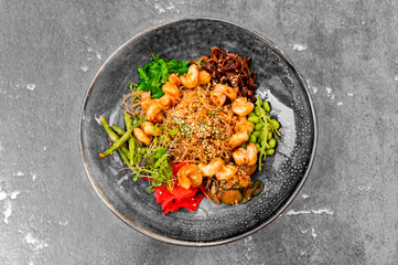 Salad with funchoza, shrimp and vegetables in restaurant