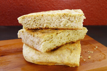 Stack of Mouthwatering Rosemary Focaccia Bread Slices on Wooden Breadboard