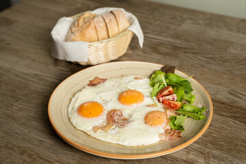 Bacon and eggs with vegetables and bread