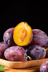 fresh ripe prune plum fruits on a wooden table, close-up
