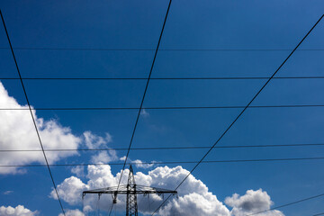 a high voltage road in front of a cloudy sky
