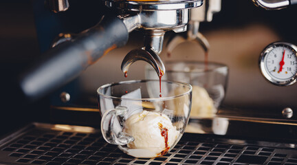 Process professional Iced espresso pouring from coffee machine to cup with ice cream in cafe, warm toning