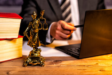 office of a lawyer with statue of Lady Justice, goddess Justitia, on the desk
