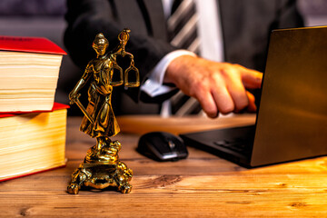 office of a lawyer with statue of Lady Justice, goddess Justitia, on the desk