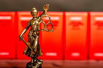 statue of Lady Justice, goddess Justitia, on the desk in a lawyer's office