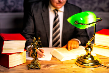 office of a lawyer with statue of Lady Justice, goddess Justitia, on the desk