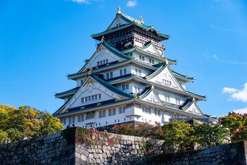 秋晴れの空と紅葉に彩られた大阪城天守閣（大阪府大阪市）