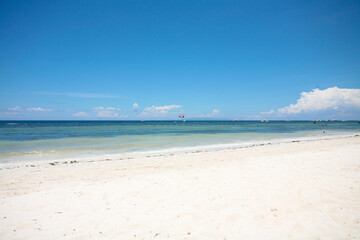 Beautiful beach with blue waters, white sand and clear sky at Alona Beach, Bohol, Philippines.