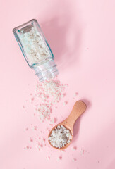 Mineral-rich sea coarse salt on a pink background. Salt harvested in the marshes of the Île de Ré in France