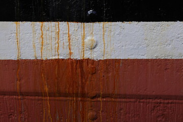 The colorful side of the ship and the rust stain
